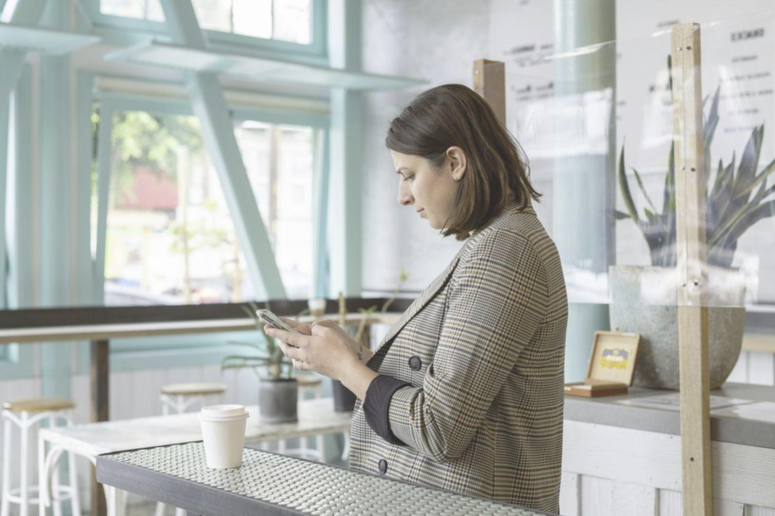 Modern office workspace with financial planning materials and coffee cup on wooden desk